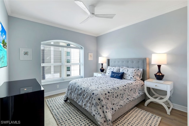 bedroom with light hardwood / wood-style flooring, ceiling fan, and ornamental molding