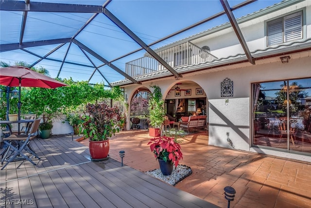 wooden terrace featuring a lanai and an outdoor hangout area