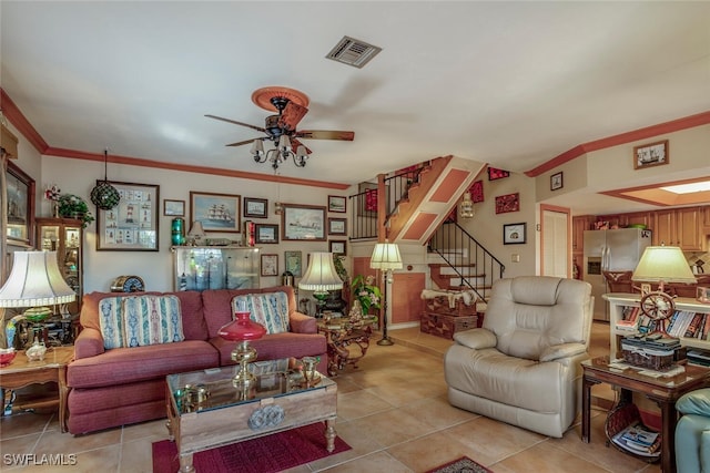 tiled living room featuring ceiling fan and crown molding