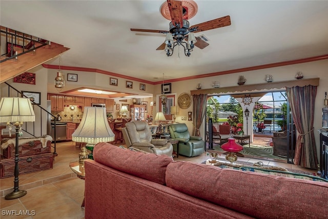 tiled living room with crown molding and ceiling fan