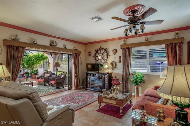 living room featuring ceiling fan, light tile patterned floors, and ornamental molding