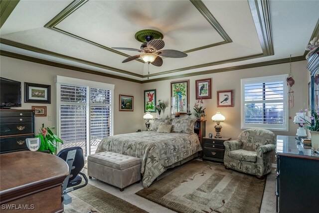 bedroom with a tray ceiling, ceiling fan, and ornamental molding