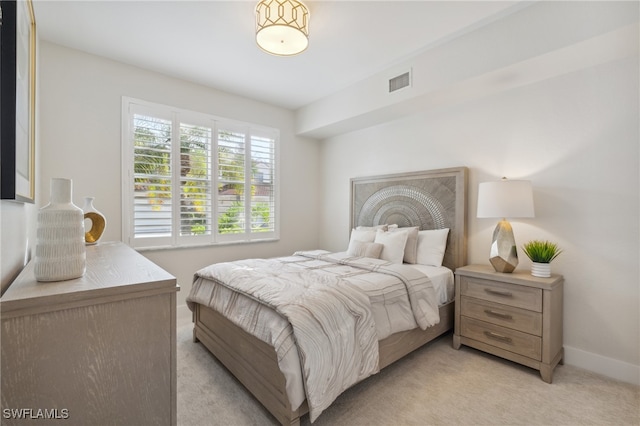 bedroom featuring light carpet