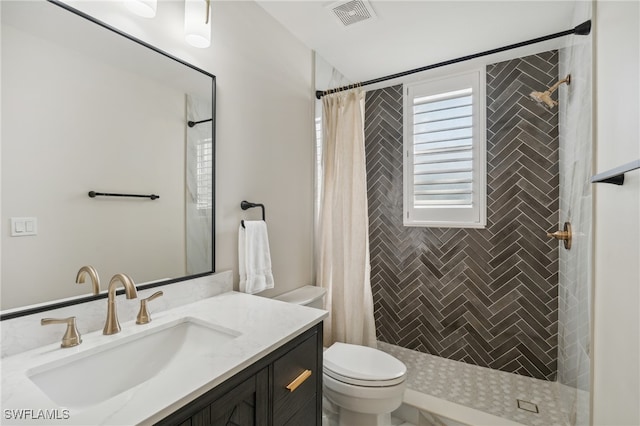 bathroom with vanity, a shower with shower curtain, and toilet