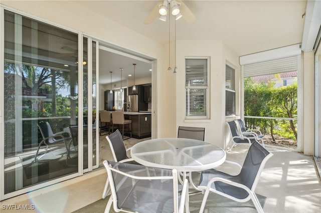 sunroom / solarium with ceiling fan