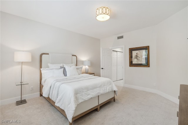 bedroom with light colored carpet and a closet