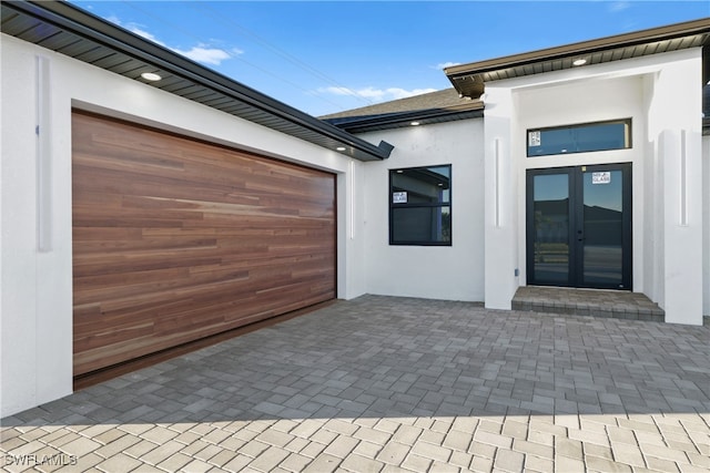 view of patio featuring a garage and french doors