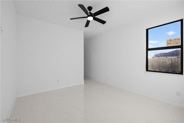 empty room with ceiling fan and a mountain view