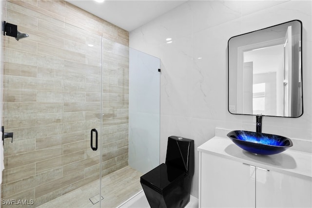 bathroom featuring vanity, tile walls, and walk in shower