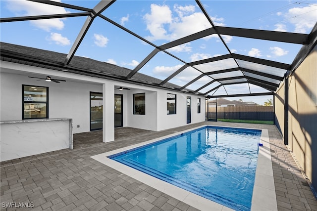 view of pool with a lanai, a patio area, and ceiling fan