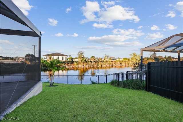 view of yard featuring a water view and a lanai