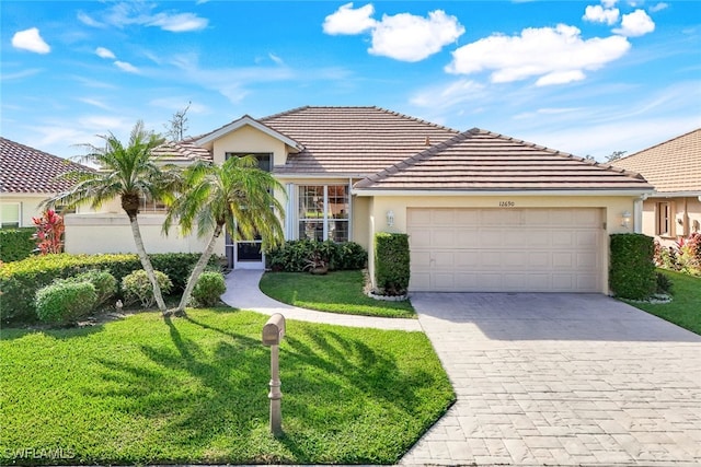 view of front of home with a garage and a front yard