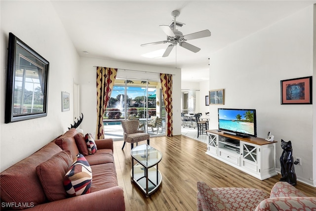 living room with hardwood / wood-style flooring and ceiling fan