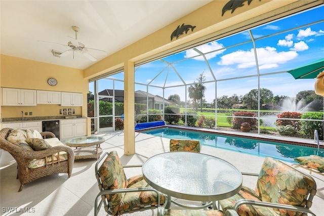 view of swimming pool with sink, a patio, ceiling fan, and exterior kitchen