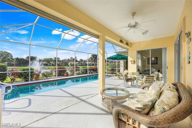 view of pool featuring a lanai, ceiling fan, and a patio