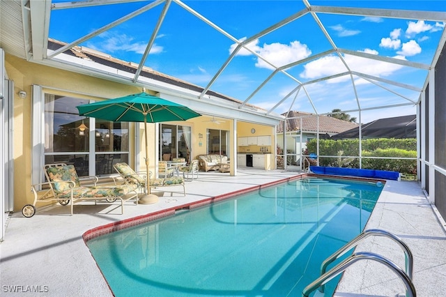 view of pool featuring a lanai, ceiling fan, and a patio area