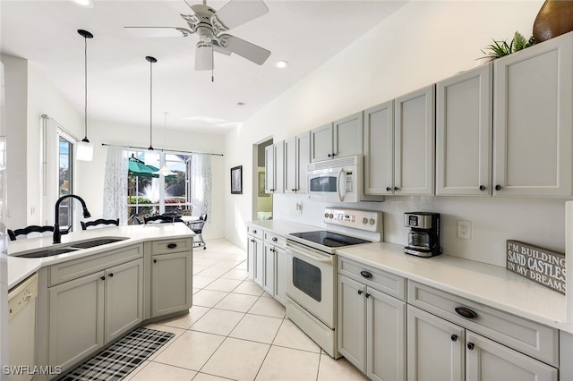 kitchen featuring gray cabinets, sink, hanging light fixtures, and white appliances