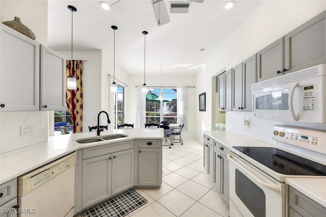 kitchen featuring gray cabinetry, pendant lighting, white appliances, and sink