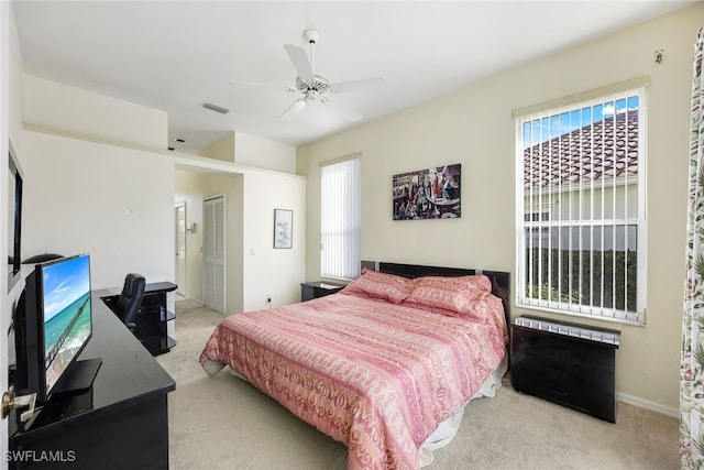 bedroom featuring ceiling fan, a closet, and light carpet