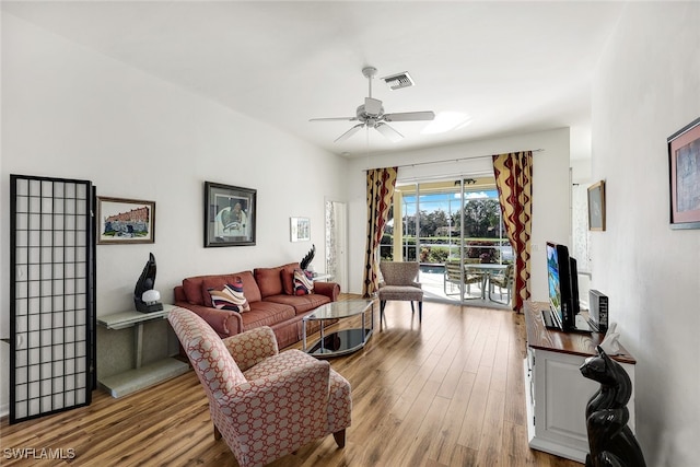 living room featuring light hardwood / wood-style floors and ceiling fan