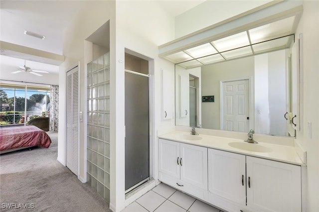 bathroom featuring vanity, tile patterned floors, ceiling fan, and a shower with shower door