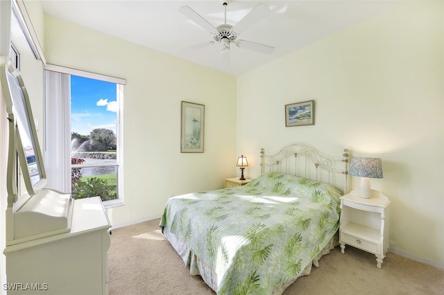 bedroom featuring ceiling fan and light carpet