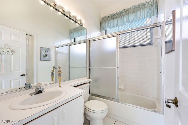 full bathroom with tile patterned floors, vanity, toilet, and enclosed tub / shower combo