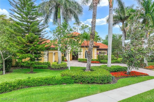 mediterranean / spanish house with a front lawn