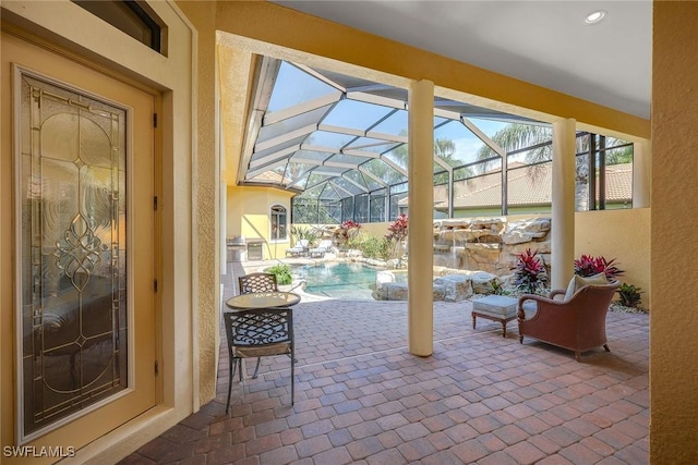 view of patio featuring a lanai