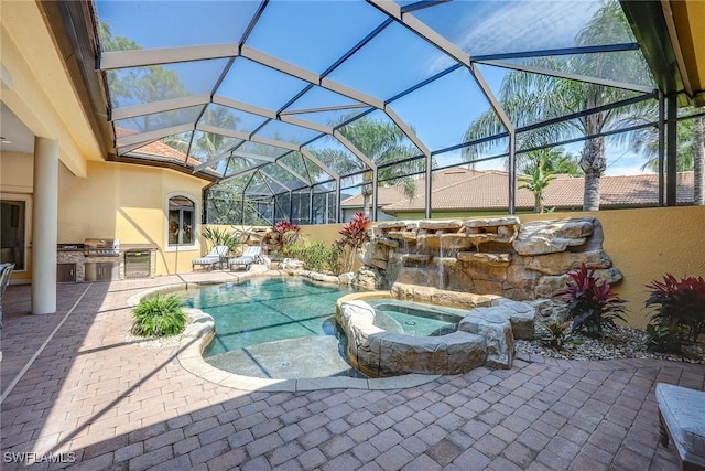 view of pool featuring a lanai, grilling area, an in ground hot tub, and an outdoor kitchen