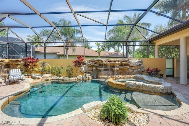 view of swimming pool featuring a lanai, an in ground hot tub, and a patio