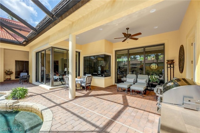 view of patio / terrace with a pool, area for grilling, and ceiling fan