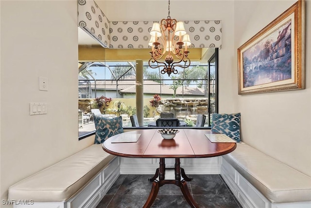 dining space featuring breakfast area, a healthy amount of sunlight, and a notable chandelier