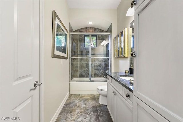 full bathroom with vanity, bath / shower combo with glass door, vaulted ceiling, and toilet