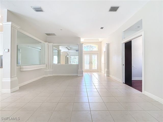 unfurnished room with french doors and light tile patterned floors