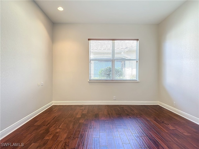 spare room with dark hardwood / wood-style flooring