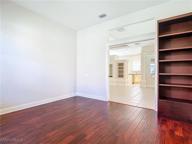 unfurnished room with wood-type flooring