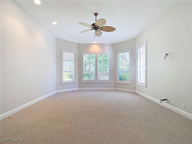 carpeted empty room featuring ceiling fan