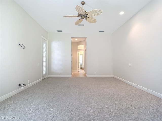 carpeted empty room featuring ceiling fan