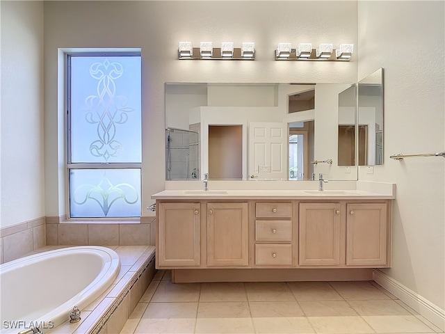 bathroom featuring tile patterned flooring, vanity, and independent shower and bath