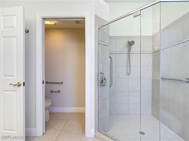 bathroom with tile patterned floors, an enclosed shower, and toilet