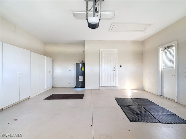 garage with a garage door opener and water heater