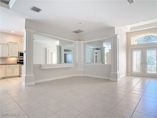 spare room with light tile patterned floors and french doors