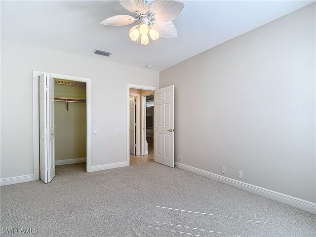 unfurnished bedroom with carpet, ceiling fan, and a closet