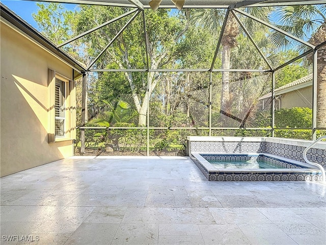 view of patio featuring a lanai and an in ground hot tub