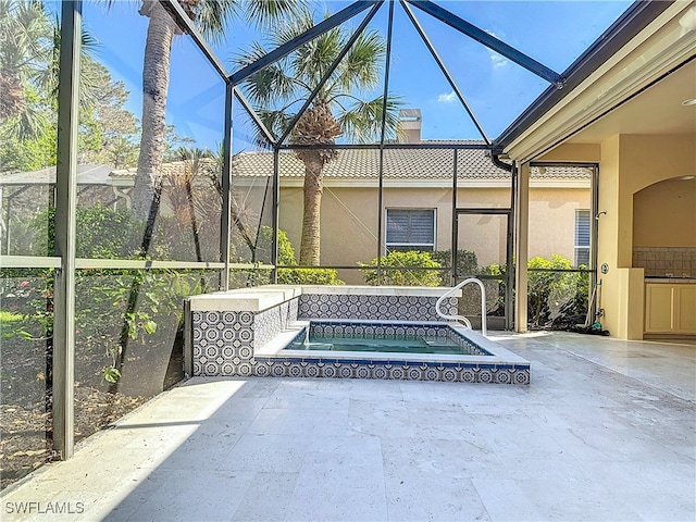 view of swimming pool with a lanai and an in ground hot tub