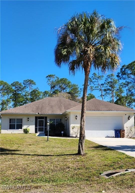 ranch-style house with a front yard and a garage