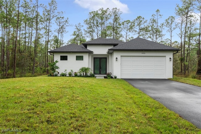 view of front of property featuring a garage and a front lawn