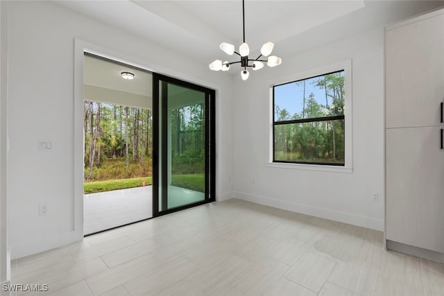 empty room with an inviting chandelier and a healthy amount of sunlight