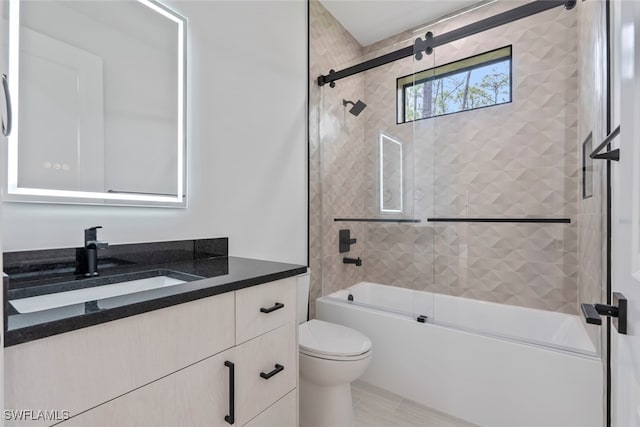 full bathroom featuring shower / bath combination with glass door, vanity, and toilet